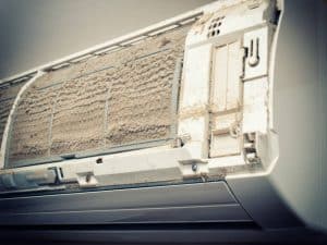 Closeup view of an open Air condition unit and very dirty air filters.